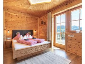 a bedroom with a bed in a wooden room at Wellness Chalet Bergschlössl in Hippach