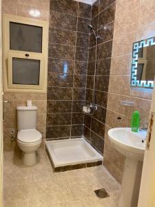 a bathroom with a shower and a toilet and a sink at luxury 3BD villa in Stella Heights - North Coast فيلا فاخره ستيلا هايتس الساحل الشمالي in El Alamein