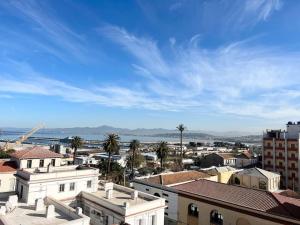 a view of a city with palm trees and buildings at Superbe appartement au cœur de Jijel in Jijel