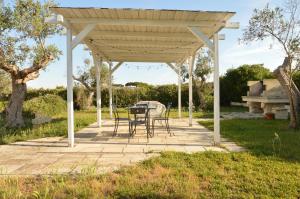 - un pavillon avec une table et des chaises sur la terrasse dans l'établissement Il Monile, à Otrante