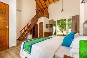 a bedroom with a large bed and a staircase at Tranquil Wild in Tanamalwila