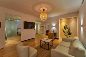 a living room with a couch and a tv at New President Hotel Cairo in Cairo