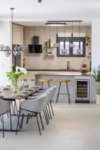 a kitchen and dining room with a table and chairs at Luxury Villa My Wish with Pool in Kastel Stari