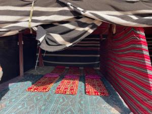 a room with three mats on the floor of a tent at חאן נחל חווה Han Nahal Hava in Mitzpe Ramon