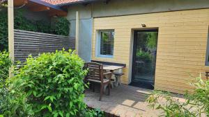 a patio with a table and a bench on a house at Apartmán YASNE in Ostrava