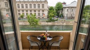 布加勒斯特AIASTAY Bucharest River Apartments的带桌椅的阳台，可欣赏美景