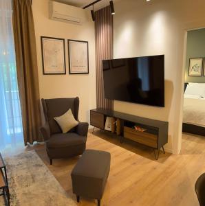 a living room with a large flat screen tv at Apartments INCIS next to the Pula Amphitheather in Pula