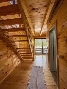 an attic room with wooden walls and a wooden ceiling at Mini Tri in Ulcinj