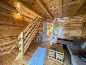 a room with a staircase in a log cabin at Mini Tri in Ulcinj