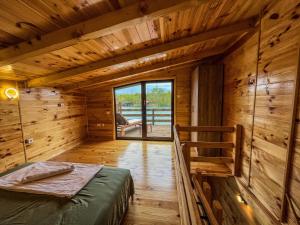 a room with a bed in a wooden cabin at Mini Tri in Ulcinj