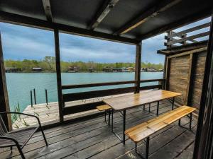 a wooden deck with a table and a bench at Mini Tri in Ulcinj