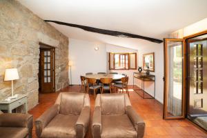 a living room with a table and chairs at Casa da Eira by Quantique in Amares