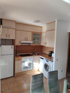 a kitchen with a washing machine and a washer at Villa Punta Calma in Majanicho