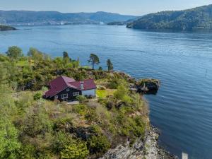 a house on the edge of a body of water at Villa Ocean View in Askøy