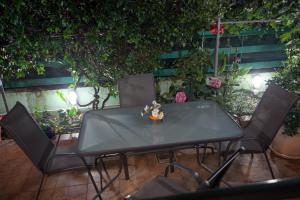 a table and chairs in a garden with flowers at Villa Veneti in Néos Pírgos