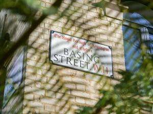 a sign on the side of a brick building at Three-Bedroom Bohemian Haven in London