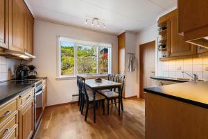 a kitchen with a table and chairs and a window at Villa Ocean View in Askøy