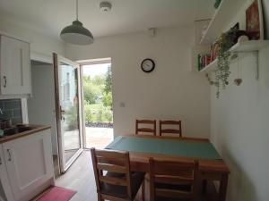 a kitchen and dining room with a table and chairs at Galway Riverside Retreat in Galway