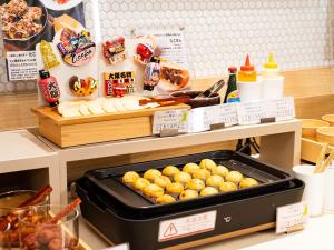 a table with a buffet of food in a store at Vessel Inn Shinsaibashi in Osaka