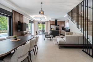 a living room with a dining table and a living room at NEW! Luxury Villa Carlotte with 11m pool in Poreč