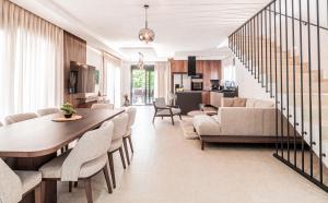 a dining room and living room with a table and chairs at NEW! Luxury Villa Carlotte with 11m pool in Poreč