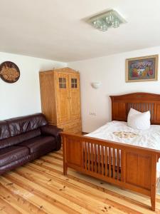 a bedroom with a bed and a couch at Прикарпаття in Kosiv +32 photos