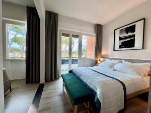 La Serena Hotel FDM في فورتي دي مارمي: غرفة نوم بسرير كبير مع مقاعد خضراء