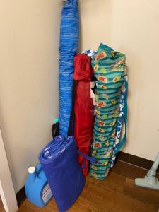 a pile of bags sitting next to a wall at Free parking Comfy central Waikiki in Honolulu