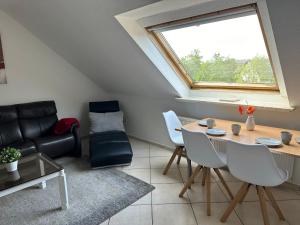 a living room with a table and a couch at Aminas Ferienwohnung Bad Gandersheim 30/2 in Bad Gandersheim