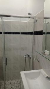 a bathroom with a glass shower and a sink at Acheron rooms in Preveza +73 photos