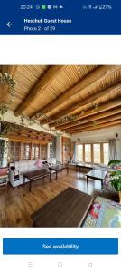 a living room with couches and tables in it at Heschuk Guest House in Leh