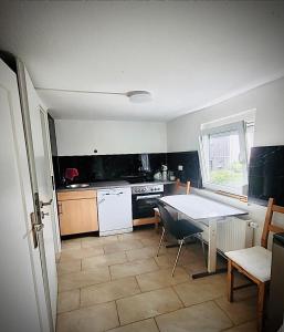 a kitchen with a table and a table and chairs at Monteurunterkunft für 8 Personen nähe Ulm in Schelklingen