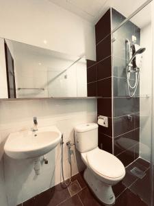 a bathroom with a toilet and a sink at The Majestic Ipoh Town - Mountain View in Ipoh