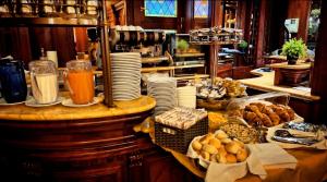 a kitchen with a counter with food and plates on it at Hotel Lux in Venice
