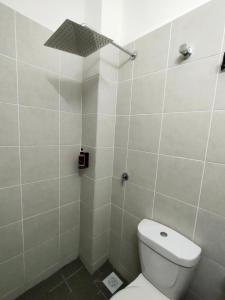 a bathroom with a toilet and a shower at FIRASH HOMESTAY AT SERI ISKANDAR in Seri Iskandar
