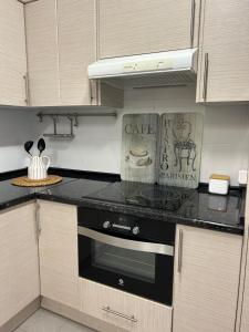 a kitchen with a black stove top oven at Acogedor apartamento en Gernika in Guernica y Luno