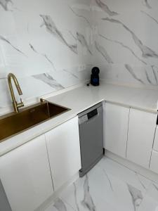 a white kitchen with a sink and a dishwasher at altea, luxury hills in Altea