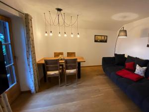 a living room with a table and a couch at Summererhof Hausham in Hausham