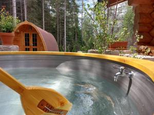 a hot tub in a backyard with a water fountain at Ferienhaus - Chalet - Lechtraum in Stanzach