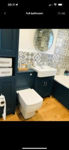 a bathroom with a toilet and a sink at Newly Renovated 5 Star Cosy-Up Romantic Cottage NEAR LONGLEAT in Warminster