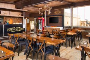 a dining room with wooden tables and chairs at World Cave House - Hotel & Swimming Pool in Ürgüp