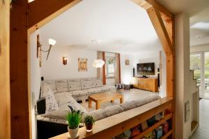 a living room with a couch and a table at Villa Jenny mit Pool in Wohlenhagen