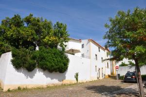 a white building with trees on the side of it at Casa Flor de Lis, Sardoal in Sardoal