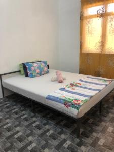 a bed sitting in a room with at Homestay Idaman B B with 2 room aircond 2 Quen Bed and Not Sharing Room -Privacy in Kuala Terengganu