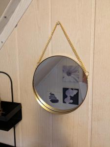a gold mirror hanging on a wall at Kuscheliges Mini-Vintage-Zimmer in Felsberg