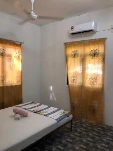 a room with a bed with curtains and a heater at Homestay Idaman B B with 2 room aircond 2 Quen Bed and Not Sharing Room -Privacy in Kuala Terengganu