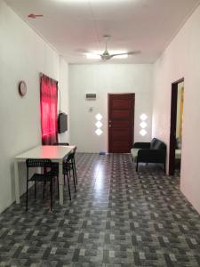 a living room with a table and chairs and a couch at Homestay Idaman B B with 2 room aircond 2 Quen Bed and Not Sharing Room -Privacy in Kuala Terengganu