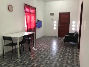 a room with a table and chairs and a door at Homestay Idaman B B with 2 room aircond 2 Quen Bed and Not Sharing Room -Privacy in Kuala Terengganu