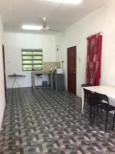 an empty room with a table and chairs at Homestay Idaman B B with 2 room aircond 2 Quen Bed and Not Sharing Room -Privacy in Kuala Terengganu