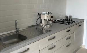 a kitchen with a mixer on a counter next to a sink at cerasella house in Castellammare di Stabia